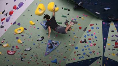 Dynamic bouldering on the steep climbing wall at summit strength and fitness