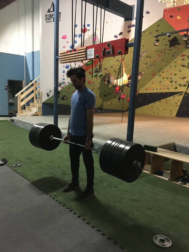 Man doing a barbell deadlift for a one rep max. training with the seasons off season