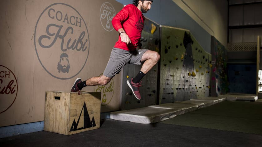Coach Kubi in Action during a workout that is built around seasonal training and training with the seasons for mountain athletes. He is doing a single leg box jump