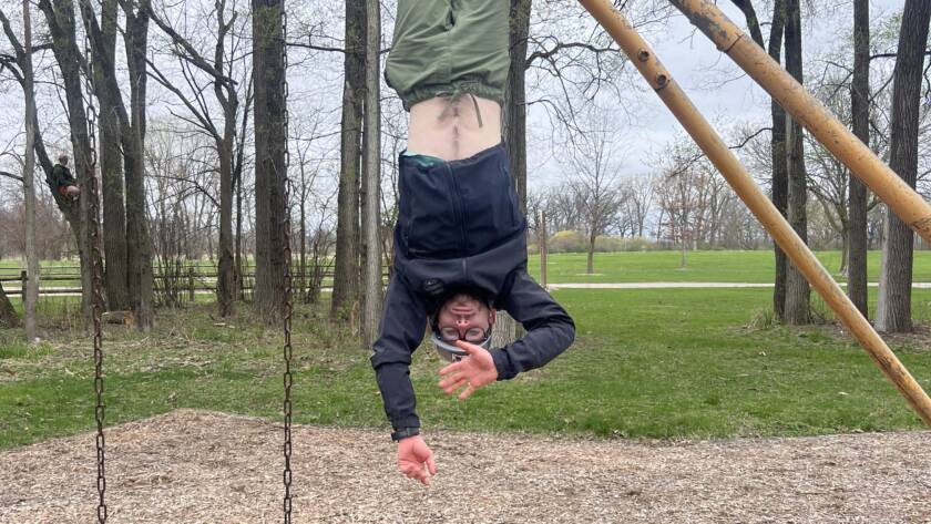Patrick Hanging upside down doing calisthenics at the playground