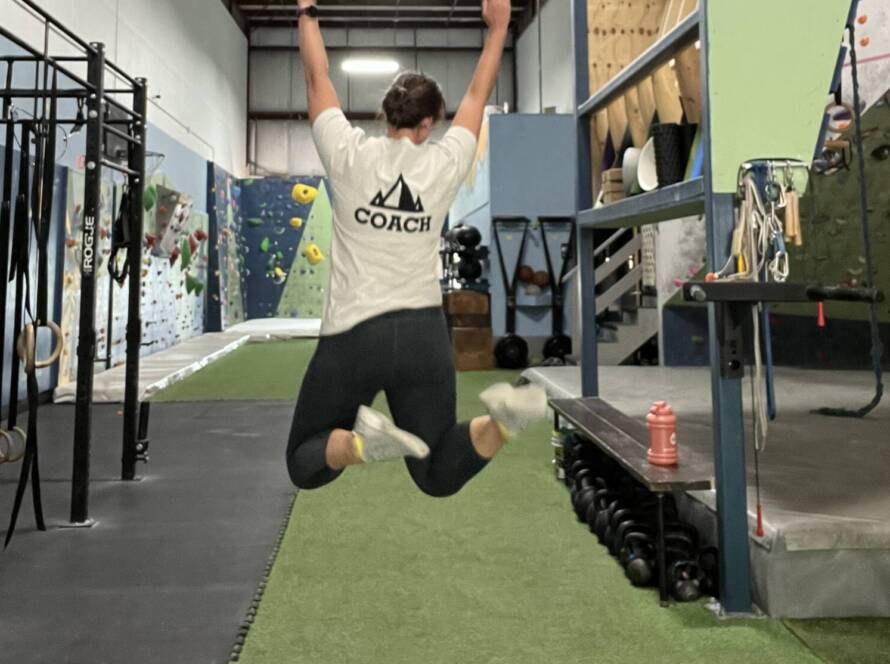 Coach Courtney jumping at summit