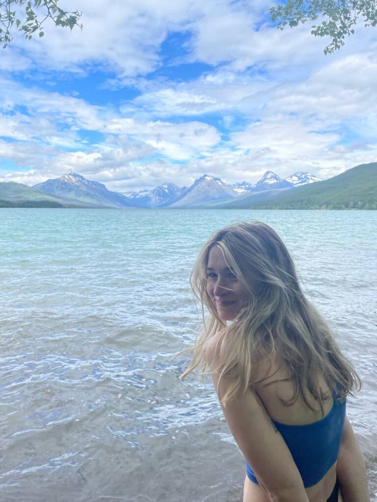 Tess sitting on a mountain lake evolving into summer
