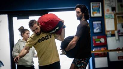 Patrick and coach kubi carrying sandbags and building strength using the mindset of a professional
