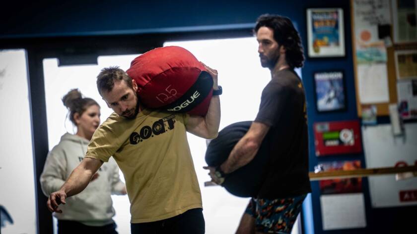 Patrick and coach kubi carrying sandbags and building strength using the mindset of a professional