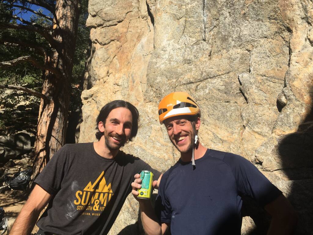 Coach Kubi and a friend participate in mountain sports such as rock climbing in Colorado