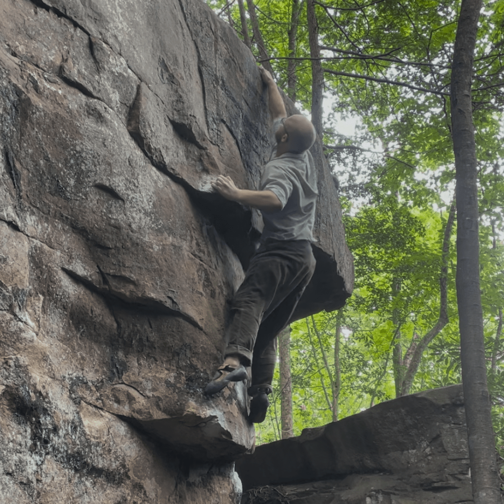 Eamon boulders on one of his climbing goals