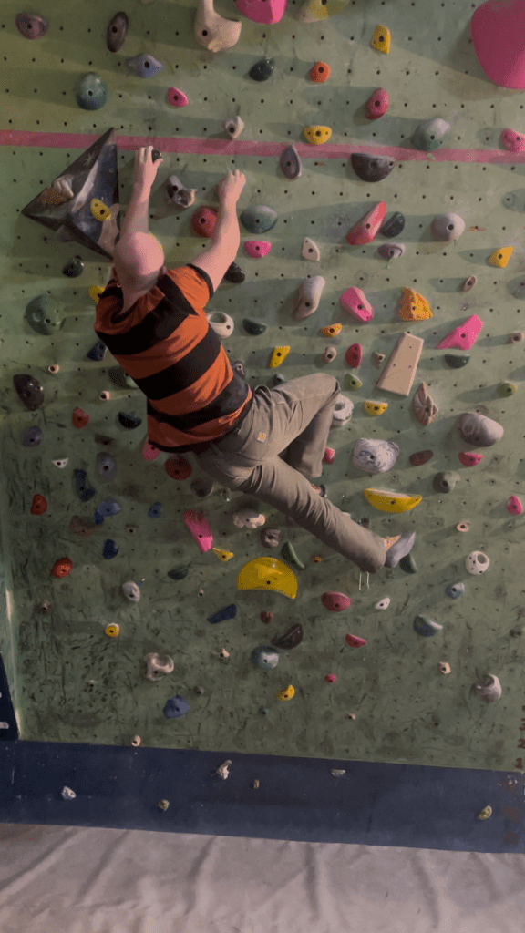 Eamon climbing on the spray wall at summit
