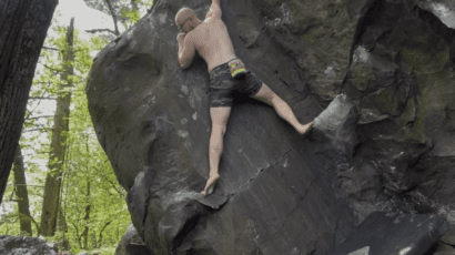 Eamon climbing a boulder outside at devils lake state park