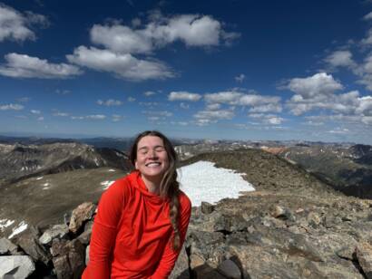 Tess enjoying the view on top of a 14er in colorado