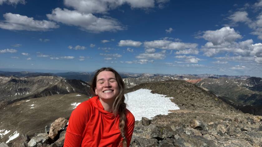 Tess enjoying the view on top of a 14er in colorado