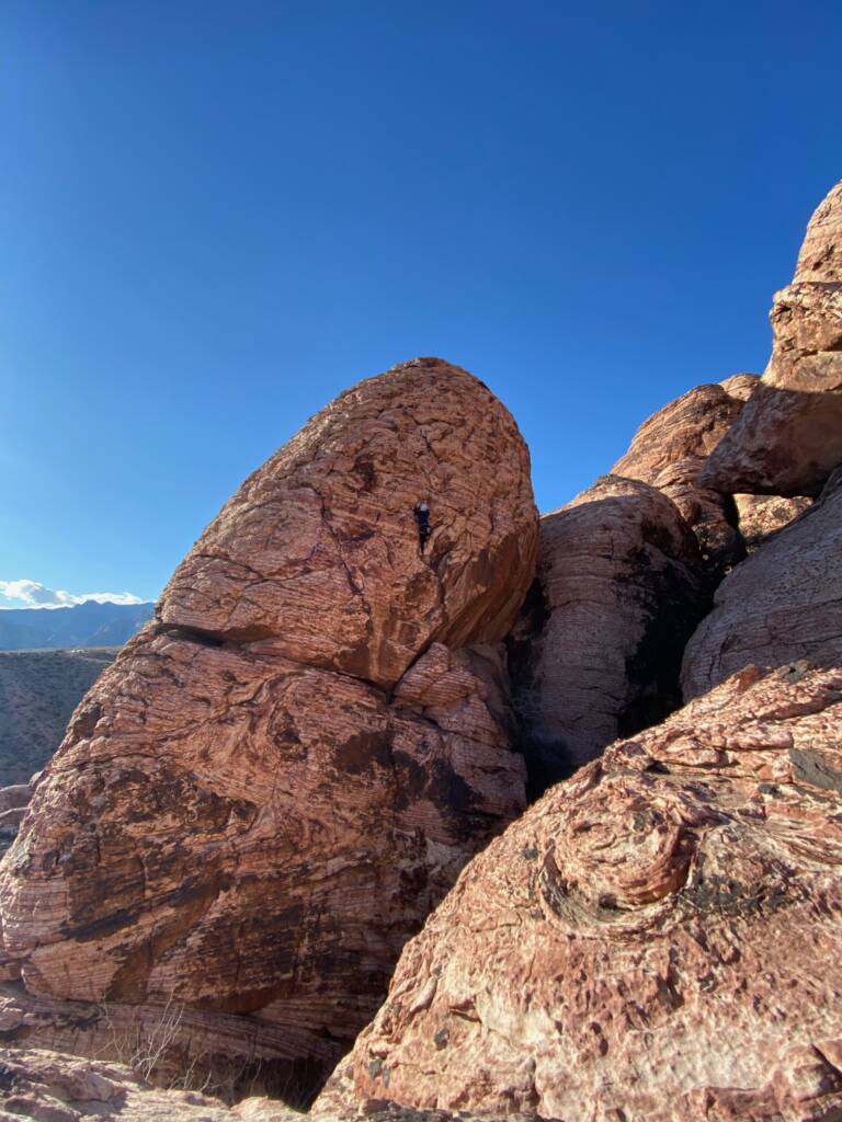 Megan topping a ropes route on outdoor climbing trip to Red Rocks