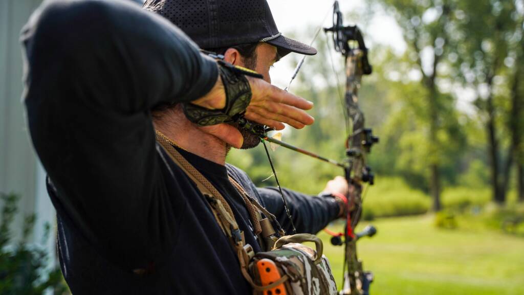 coach kubi at full draw on his hoyt bow
