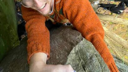Eamon is topping out on a boulder at devils lake state park in wisconsin