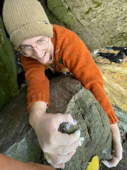 Eamon is topping out on a boulder at devils lake state park in wisconsin