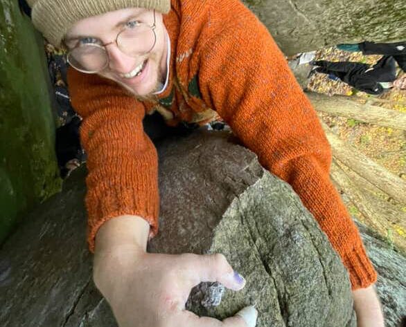 Eamon is topping out on a boulder at devils lake state park in wisconsin