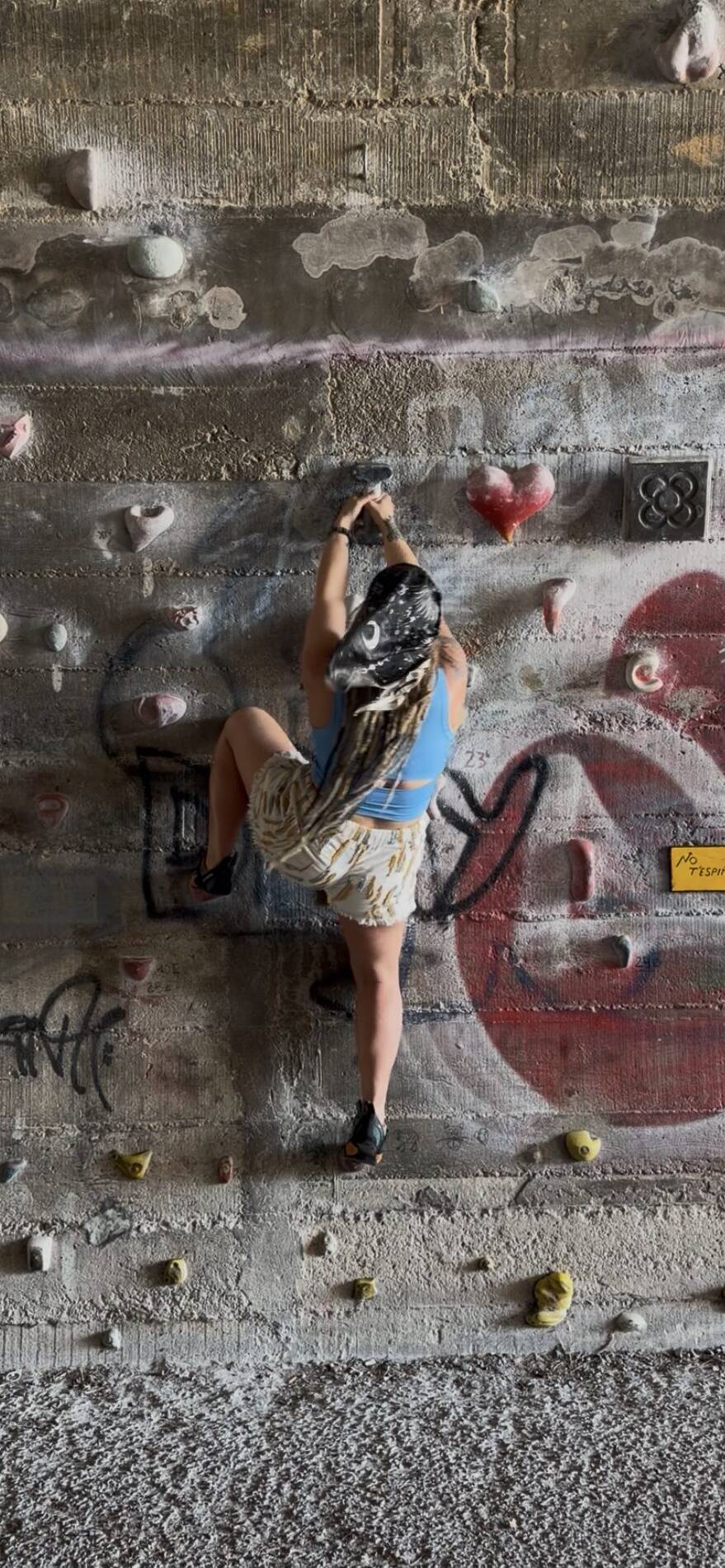 Erica climbing a wall in Spain. Applying the Strength she has from Summit Strength and Fitness  into training for real life.