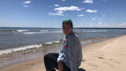 Courtney on a beach in Door County practicing rest as a recovery techniques