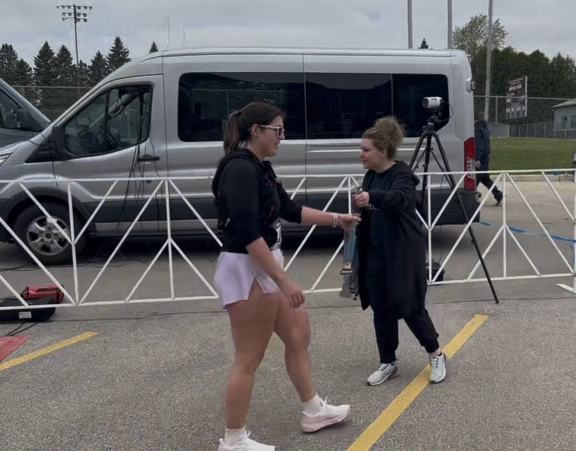 Courtney accepting her metal after the half marathon, post discussing capability vs capacity.